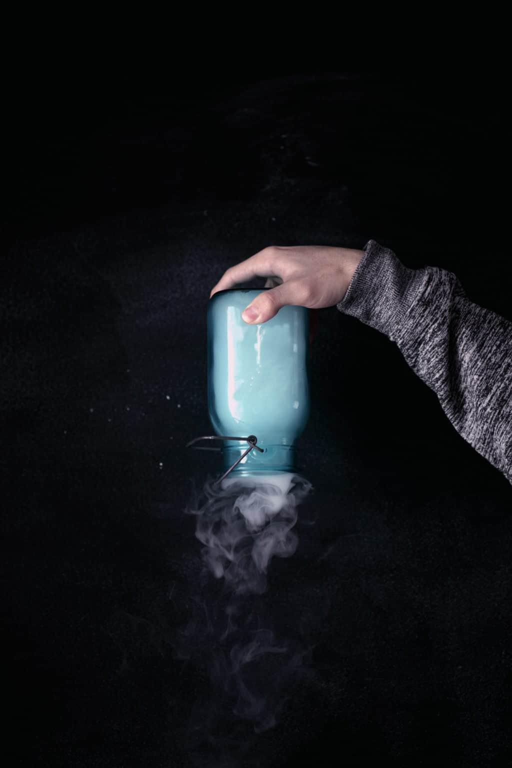 A Jar With Vape Smoke Holded Upside Down