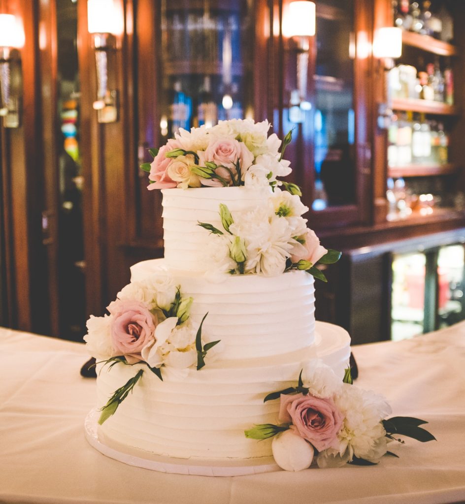 white wedding cake with pastel flowers