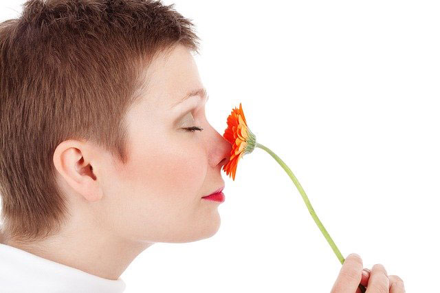 Woman smelling terpenes of flower